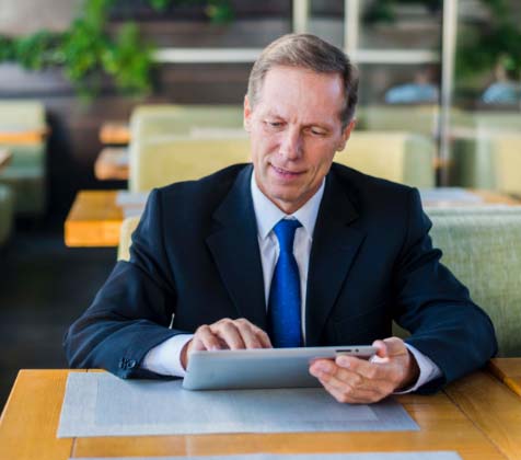 CEO using a tablet to access Convene remotely