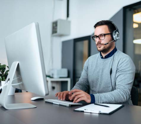 IT administrator working on his computer to manage his company&#039;s IT systems